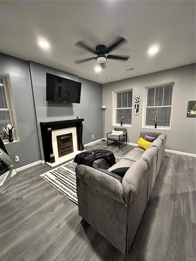 living room featuring ceiling fan and wood-type flooring