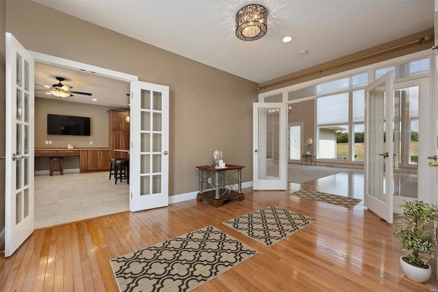 entryway featuring light hardwood / wood-style floors, french doors, and ceiling fan