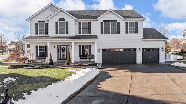 view of front of home featuring a porch, a garage, and a front yard