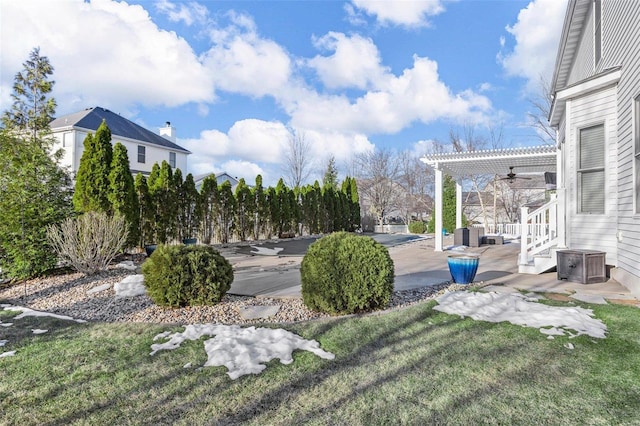 view of yard featuring a patio, ceiling fan, and a pergola