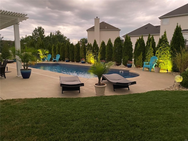 view of pool featuring a lawn, a patio area, and a pergola