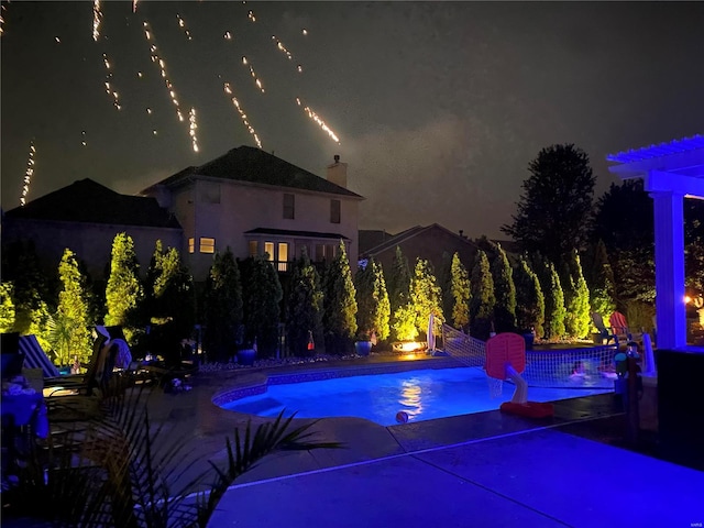 view of pool at night