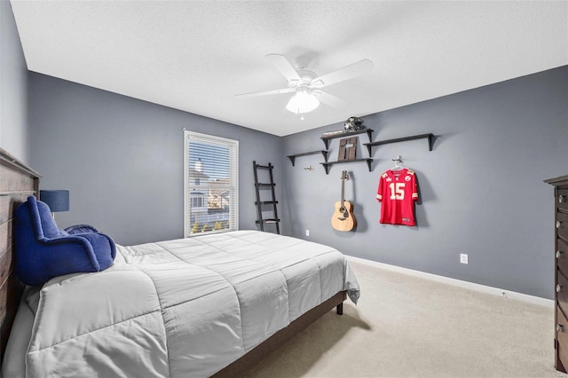 bedroom featuring carpet floors, a textured ceiling, and ceiling fan