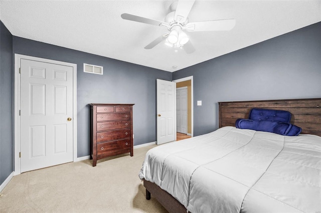 bedroom with light carpet and ceiling fan