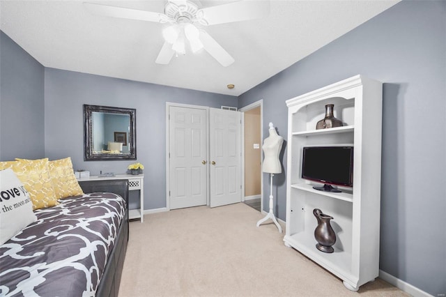 carpeted bedroom with a textured ceiling and ceiling fan