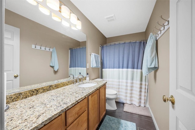 bathroom with vanity, tile patterned floors, and toilet