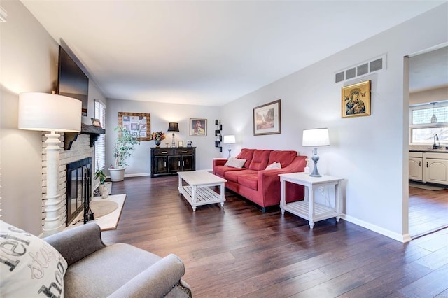 living room with dark hardwood / wood-style floors and sink