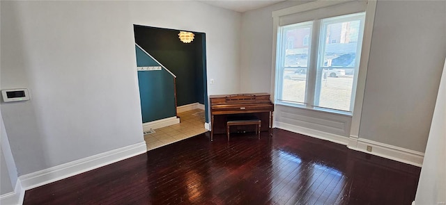 unfurnished room with hardwood / wood-style flooring and a healthy amount of sunlight