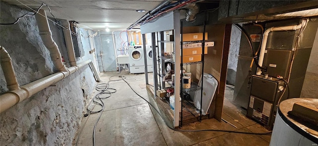 basement with heating unit and washer and dryer