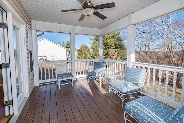 sunroom / solarium featuring ceiling fan