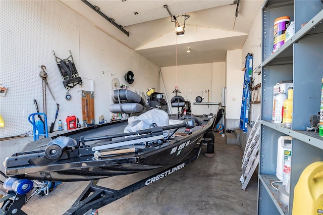 garage with a garage door opener and a workshop area