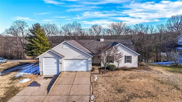 single story home featuring a garage and a front yard