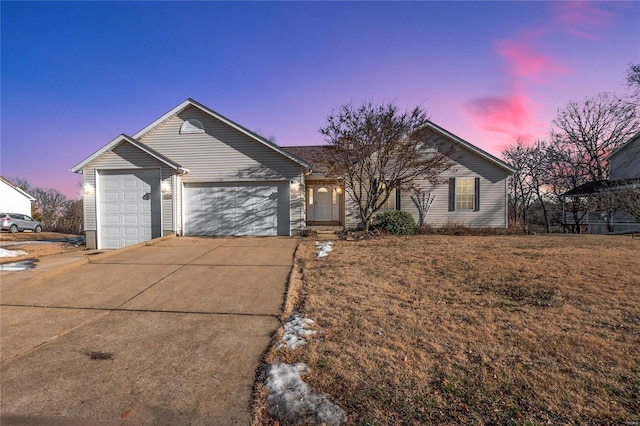 single story home with a garage and a lawn