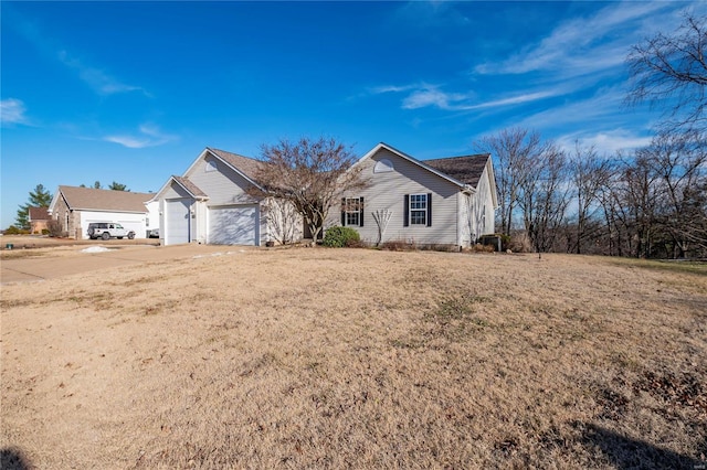 ranch-style home featuring a garage and a front lawn