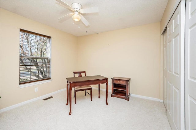 office with ceiling fan, light carpet, and a textured ceiling