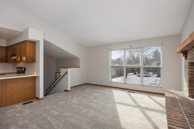 unfurnished living room featuring a fireplace and light carpet