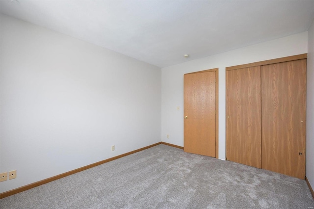 unfurnished bedroom with light carpet and two closets