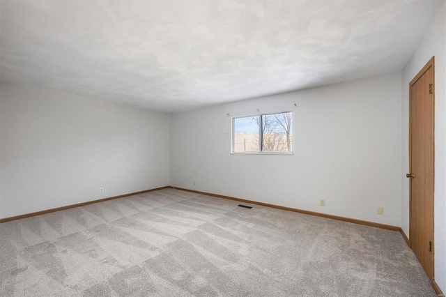 spare room with light carpet