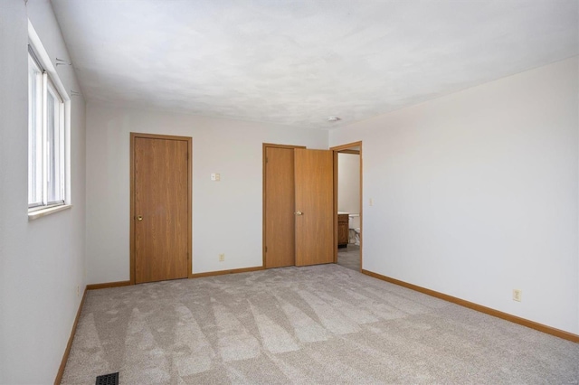 unfurnished room with light colored carpet