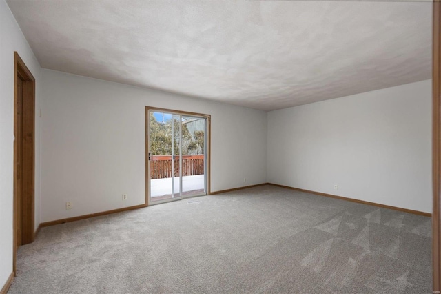 empty room featuring carpet flooring and a textured ceiling