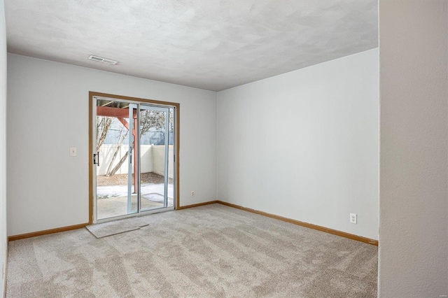 spare room with light colored carpet