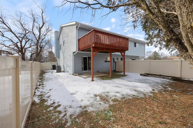 rear view of house featuring central AC and a deck