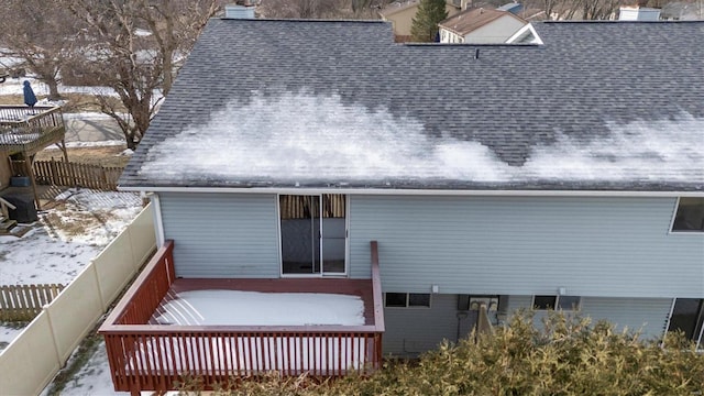 snow covered property featuring a wooden deck