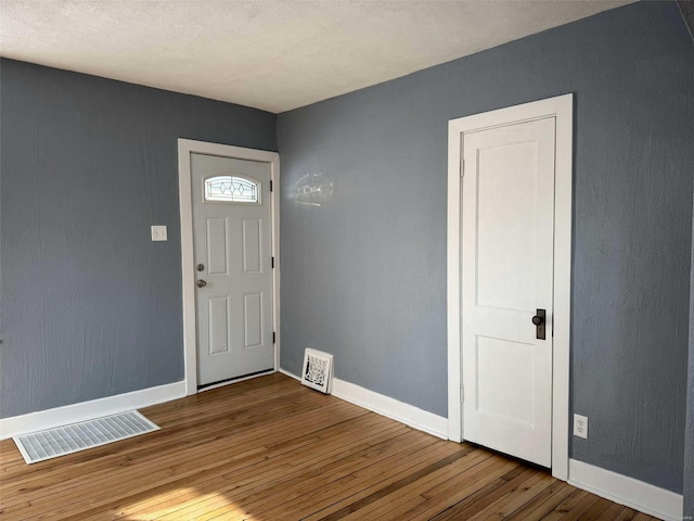 foyer entrance featuring hardwood / wood-style floors