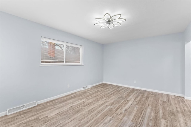 unfurnished room with light hardwood / wood-style flooring