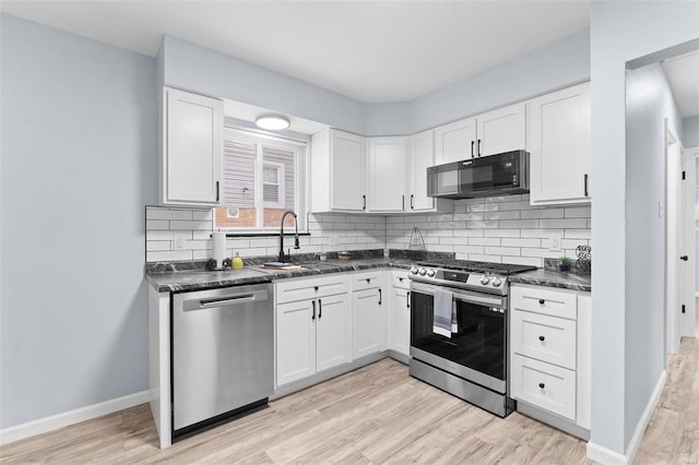 kitchen featuring sink, stainless steel appliances, white cabinets, and light wood-type flooring