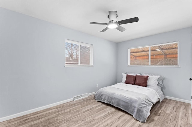 bedroom featuring light hardwood / wood-style flooring and ceiling fan