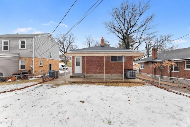 snow covered property featuring central AC unit