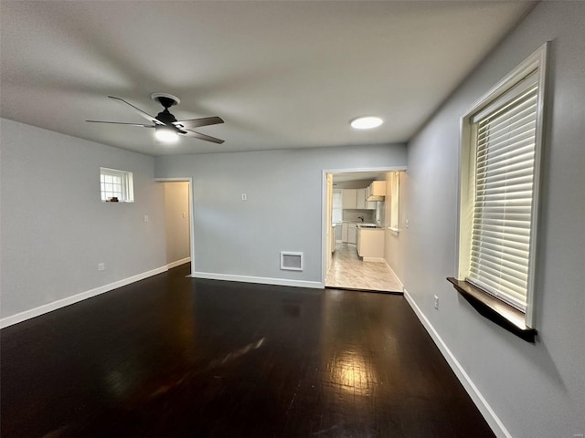 unfurnished room featuring ceiling fan and dark hardwood / wood-style flooring