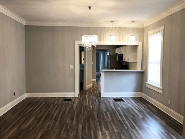 kitchen featuring pendant lighting, dark wood-type flooring, stainless steel refrigerator, and an inviting chandelier