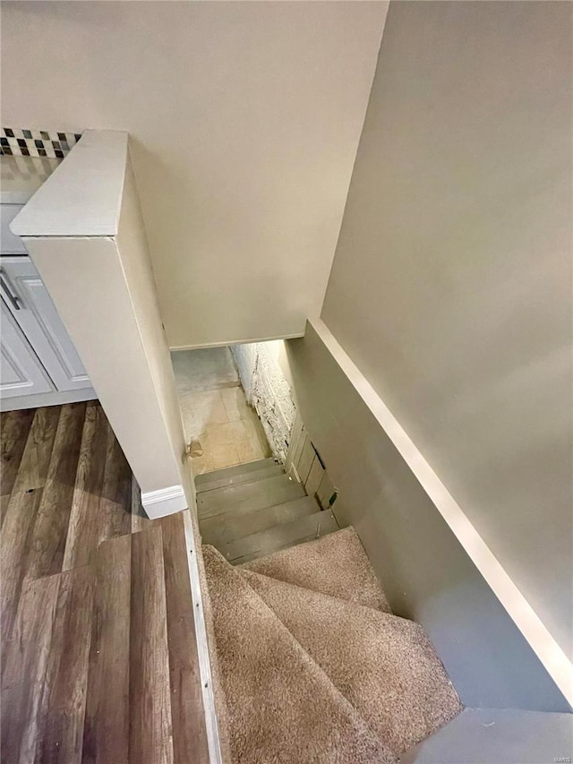 stairs with wood-type flooring