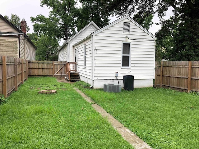 exterior space with central AC unit and a fire pit