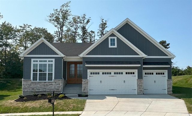 craftsman-style house with a garage, a front lawn, and french doors