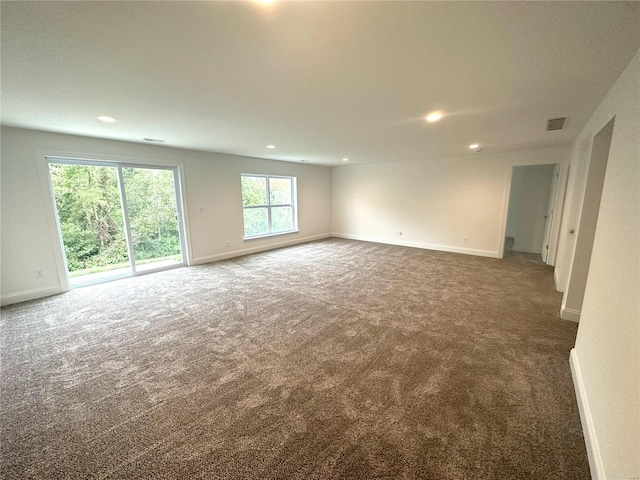 unfurnished room with dark carpet