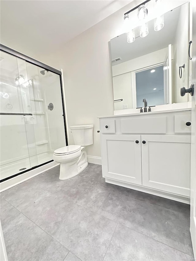 bathroom featuring walk in shower, vanity, and toilet