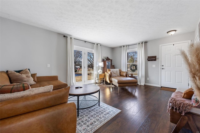 living room featuring dark hardwood / wood-style floors and a textured ceiling