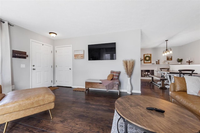 living room with a notable chandelier and dark hardwood / wood-style floors