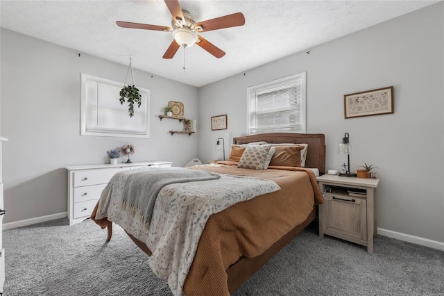 carpeted bedroom featuring ceiling fan and a textured ceiling