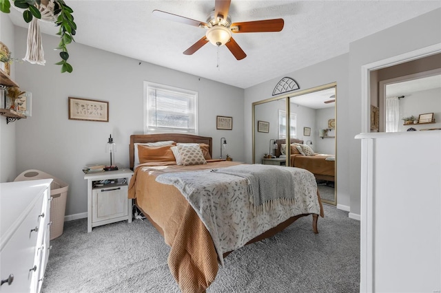 bedroom featuring light carpet, ceiling fan, and a closet