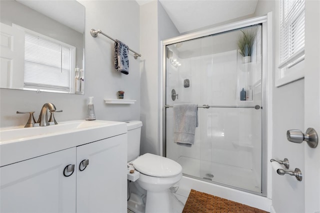 bathroom featuring an enclosed shower, vanity, and toilet