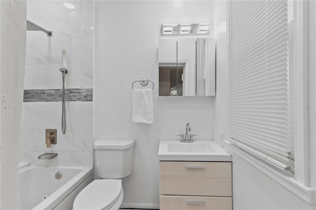 full bathroom featuring vanity, tiled shower / bath combo, and toilet