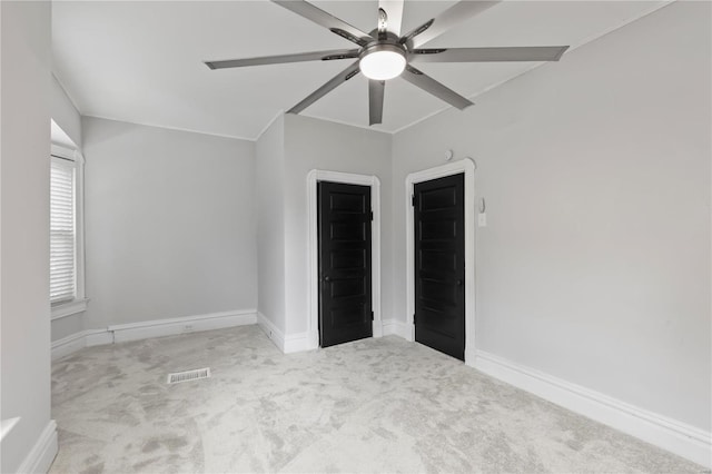 unfurnished bedroom with light colored carpet and ceiling fan