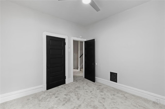 unfurnished bedroom featuring light carpet and ceiling fan