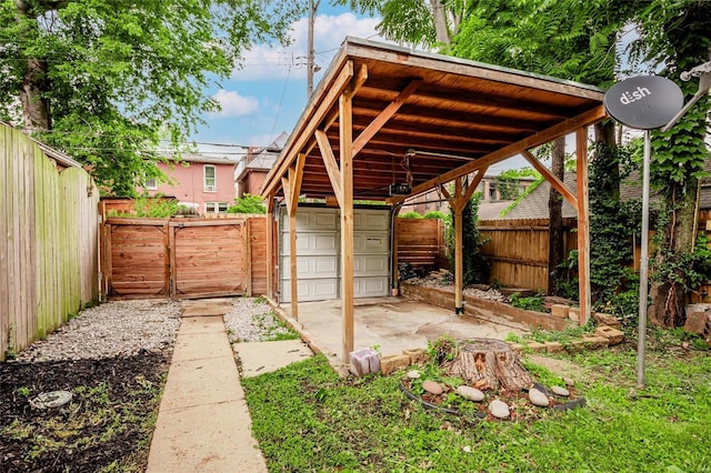 view of yard featuring a garage, an outdoor structure, and a carport