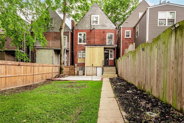 back of property featuring central AC and a lawn