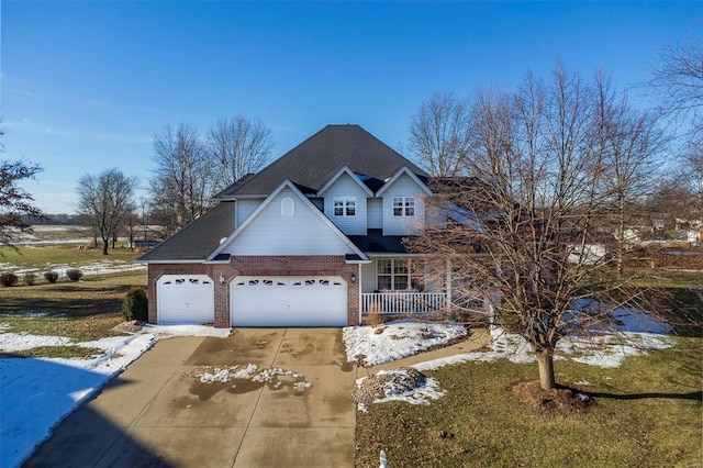 view of front of house with a garage, covered porch, and a front lawn